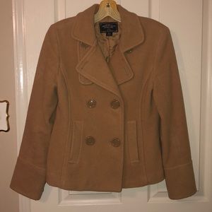 Woman’s tan peacoat